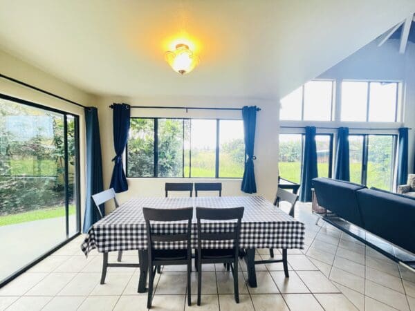 A dining room table with black and white checkered tablecloth.