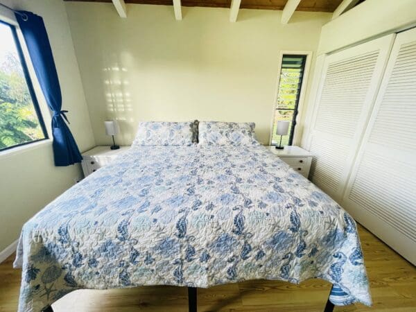 A bed with blue and white sheets on it