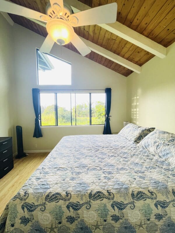 A bedroom with a large bed and a window.