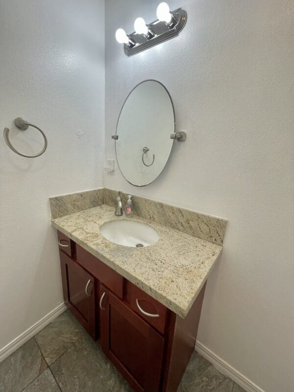 A bathroom with a sink and mirror in it