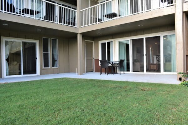 A patio with chairs and tables outside of the building.