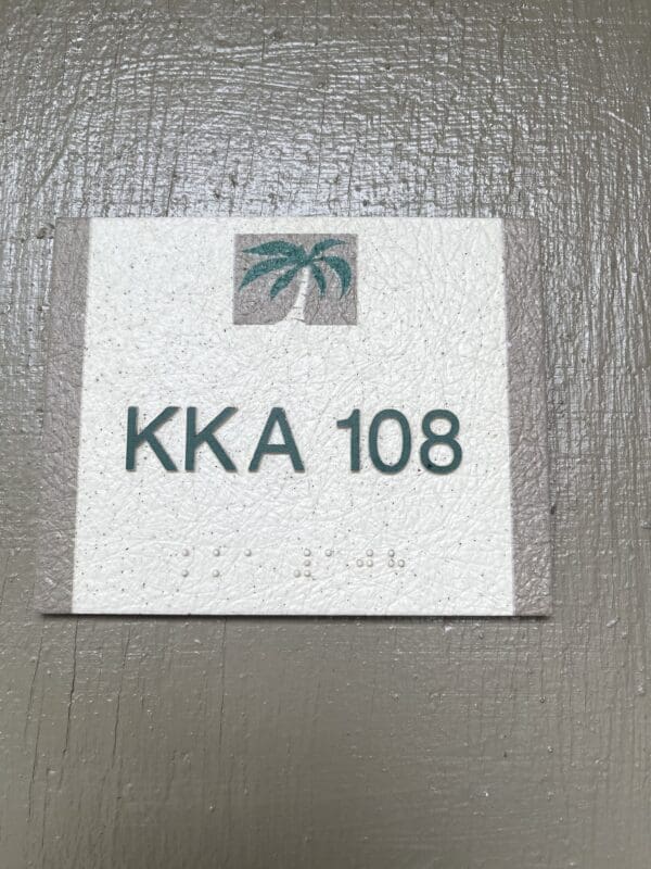 A sign on the wall that says " kka 1 0 8."