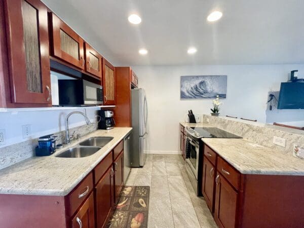 A kitchen with a sink, microwave and refrigerator.