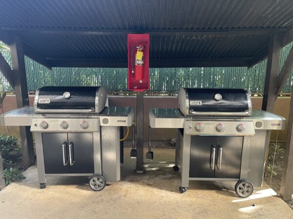 Two grills are sitting in a parking lot.