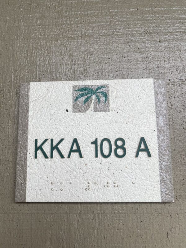 A white sign with the words " kka 1 0 8 a ".