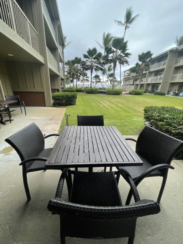 A table and chairs outside of an apartment building.