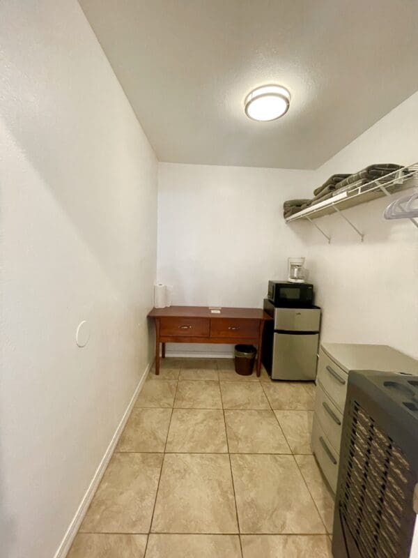 A room with a desk and a filing cabinet.