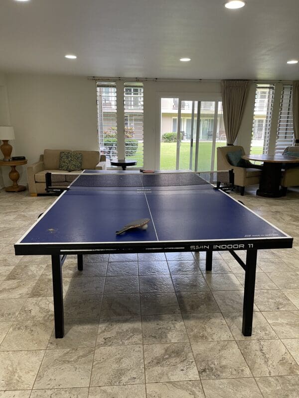 A ping pong table in the middle of a room.