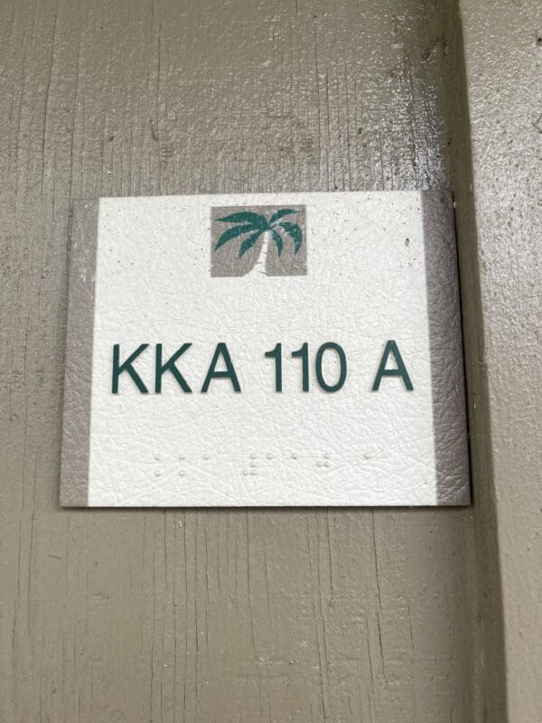 A sign on the wall that says " kka 1 1 0 a ".