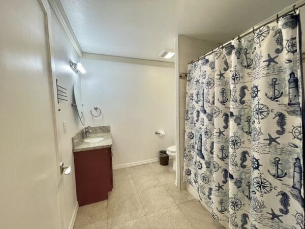 A bathroom with a sink, toilet and shower.