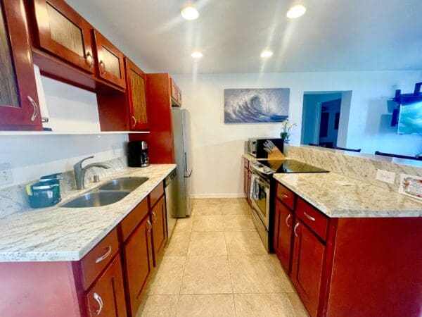 A kitchen with wooden cabinets and granite counter tops.