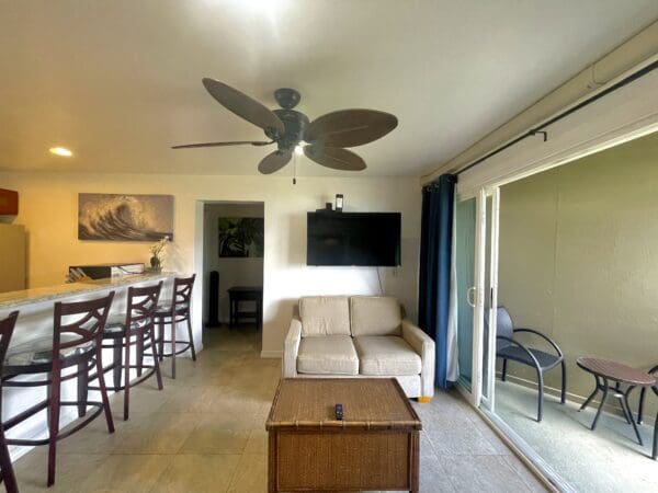 A living room with a couch, table and chairs.