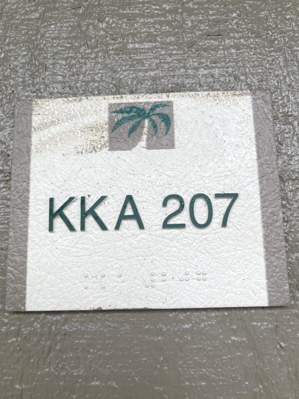 A sign on the ground that says " kka 2 0 7 ".