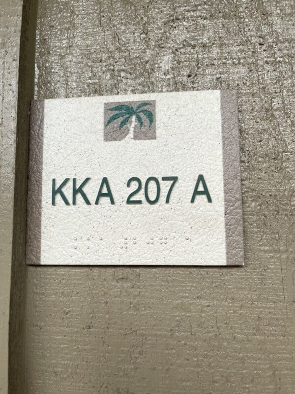 A sign on the side of a building that says " kka 2 0 7 a ".