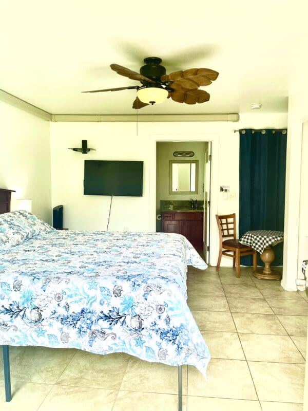 A bedroom with two beds and a flat screen tv.