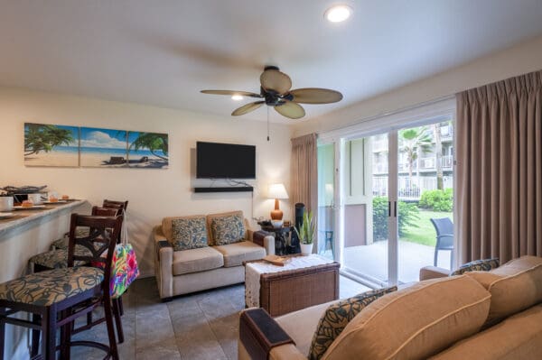 A living room with couches, chairs and a television.