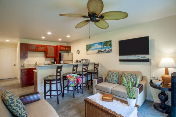 A living room with a couch, table and chairs.