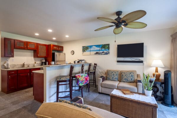 A living room with a couch, chair and television.