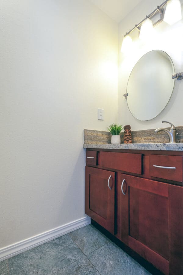 A bathroom with a sink and mirror in it