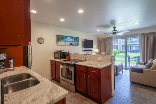 A kitchen with a stove, microwave and refrigerator.