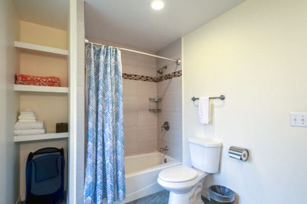 A bathroom with a toilet, tub and shower.