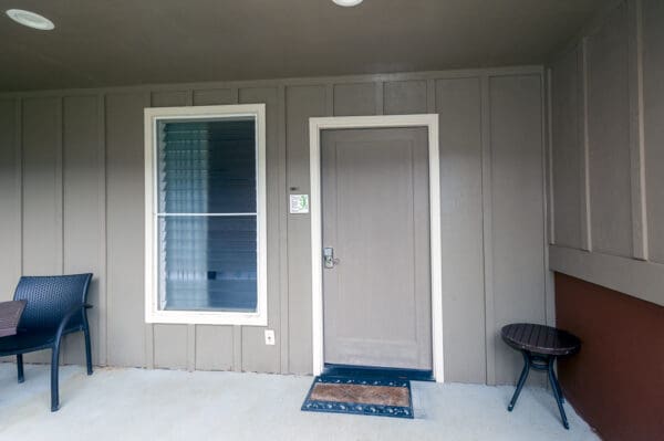 A door and window in the front of a house.